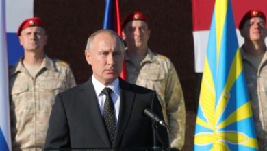 Russian President Putin addresses servicemen as he visits the Hmeymim air base in Latakia Province