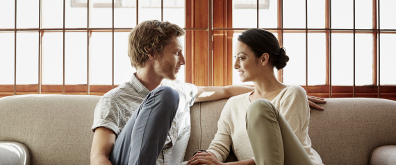 Loving couple siting on sofa at home