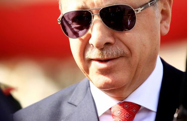 Turkey’sÊPresidentÊRecep Tayyip ErdoganÊsmiles while he arrives at Khartoum Airport
